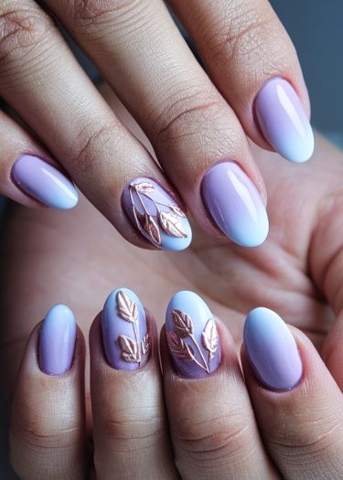 Elegant almond-shaped lavender and blue gradient nails with rose gold leaf details.