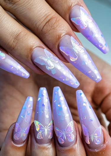 Exquisite lavender stiletto nails adorned with holographic butterfly nail art and shimmering flecks.