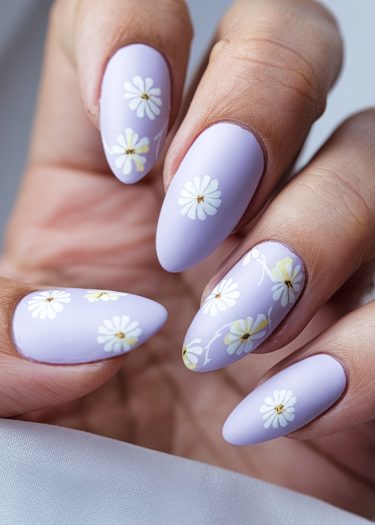 Elegant lavender nails adorned with intricate daisy designs for a sophisticated manicure.