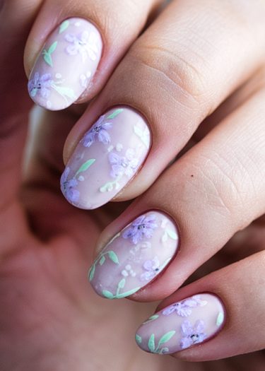 Elegant lavender floral nail art with almond-shaped nails and intricate hand-painted designs.