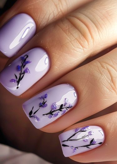 Elegant lavender floral nail art with intricate designs and glossy finish for a chic look.