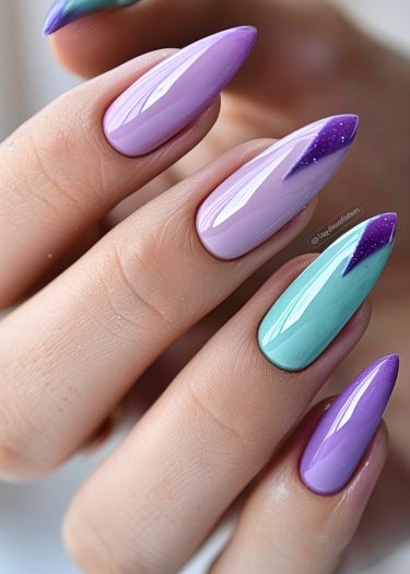 Elegant almond-shaped nails featuring lilac and teal gradient polish with glitter accents.