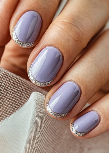 Elegant lavender nails with silver glitter accents, perfect for stylish manicures and special events.