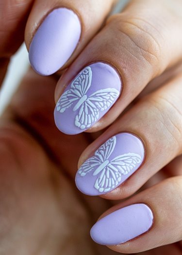 Elegant lavender matte nail art with intricate butterfly designs for a sophisticated look.