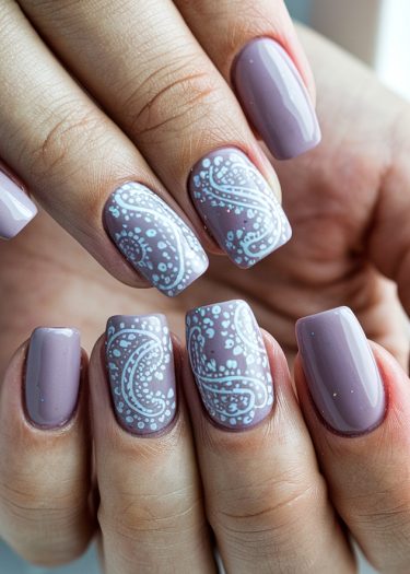 Elegant lavender nail art with intricate white paisley designs on square-shaped nails.