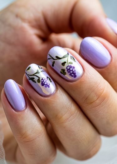 Lavender nails with grapevine art showcase elegant nail design and creative pastel manicure.