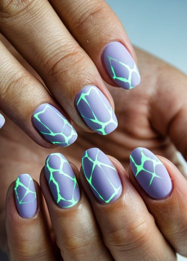 Lavender almond-shaped nails with luminous mint green patterns create stunning neon nail art.