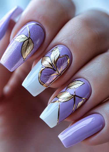 Elegant lilac and white floral nail art design with gold accents for a chic manicure.