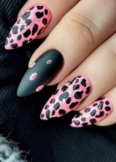 Stylish pink leopard print nail art with glitter and matte accents on almond-shaped nails.