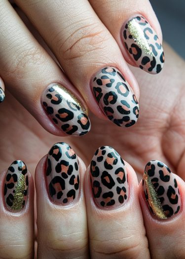 Bold leopard print nail art with metallic gold accents for a trendy manicure.