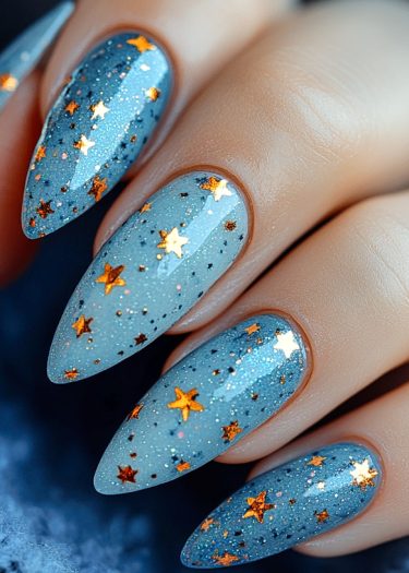 Celestial teal star nail art featuring long pointed tips and shimmering accents.