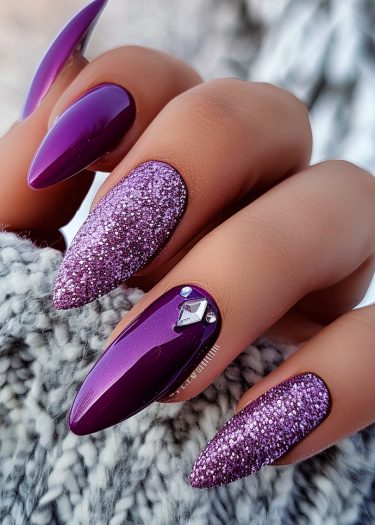 Elegant almond-shaped nails in purple and glitter, showcasing luxurious nail art and rhinestone accents.