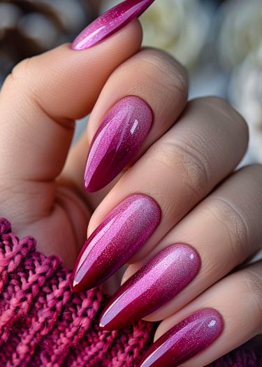 Elegant magenta gradient nails on a hand, showcasing a glossy finish and sophisticated style.