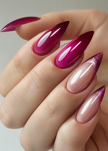 Elegant magenta ombre nails with glitter accents for a stunning manicure effect.