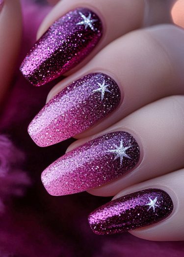 Elegant magenta-pink gradient nails with glitter, stars, and a high-shine topcoat.