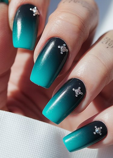 Ombre manicure featuring turquoise gradient nails with elegant diamond embellishments.