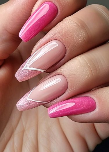 Elegant pink and nude manicure with artistic almond-shaped nail design and glitter accents.