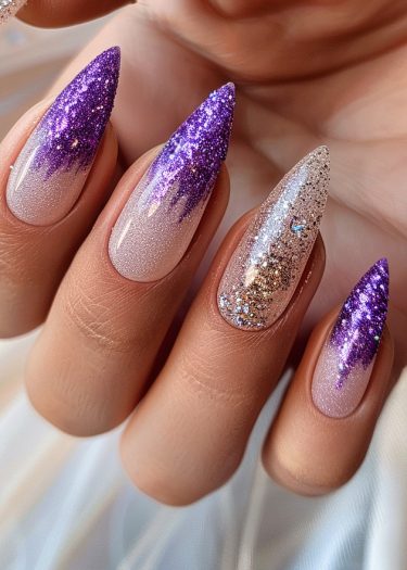 Stunning stiletto manicure featuring gradient purple nails with glitter and intricate designs.