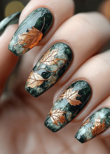 Exquisite forest green nail art with metallic copper leaves, showcasing intricate designs and craftsmanship.