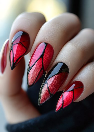 Elegant red nails with intricate stained glass design and glossy finish.