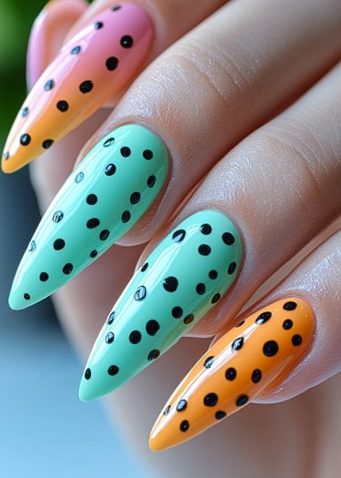 Stylish stiletto nails with colorful gradients and polka dots for trendy manicure inspiration.