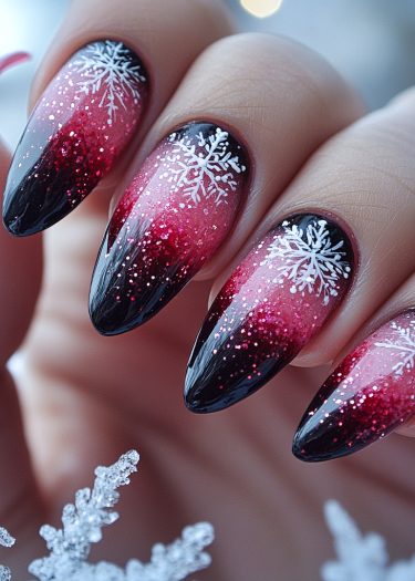 Stunning winter nail design with a black-to-pink gradient and snowflake accents.