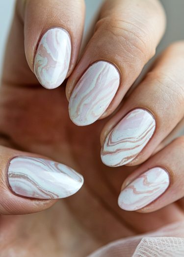 Elegant marble gradient nail art in soft pastels, showcasing meticulous manicure and glossy finish.