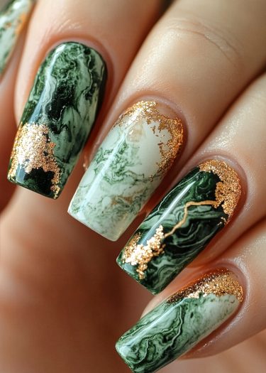 Elegant marble green and gold nail art design with luxurious detailing and sophisticated style.