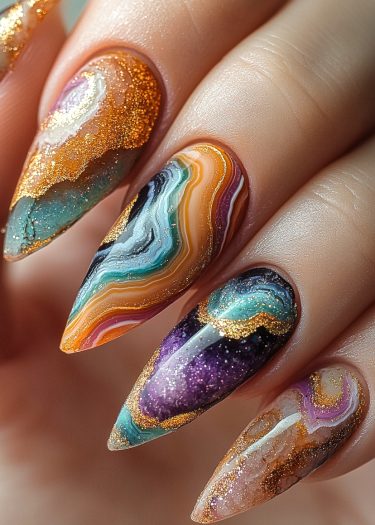 Stunning marble-pattern nails with vibrant colors and metallic accents showcasing intricate nail art design.