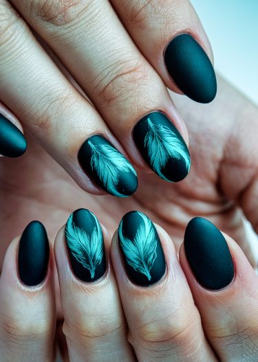 Elegant matte black nail art with turquoise feather designs for a stunning and chic look.