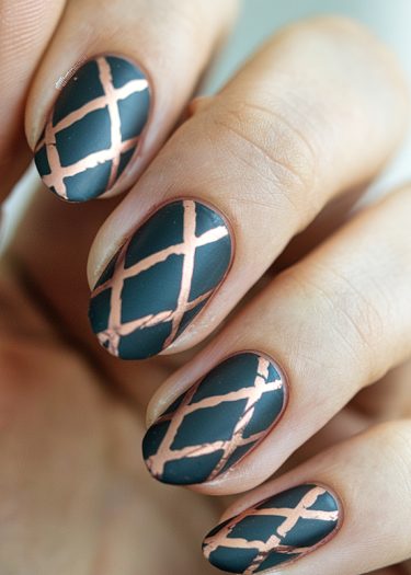 Elegant matte black nails with intricate rose gold geometric nail art design.