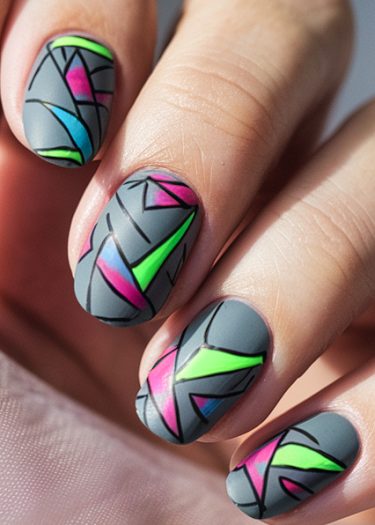 Intricate matte gray nail art featuring vibrant geometric designs in neon colors.