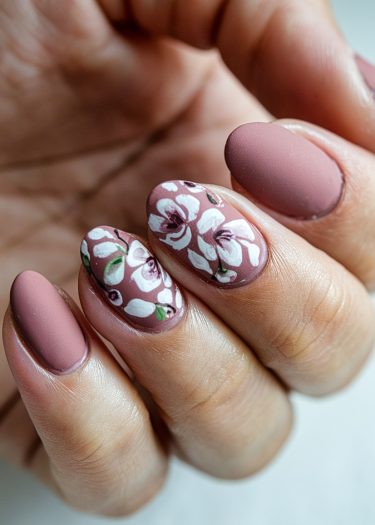 Elegant matte mauve nails with intricate floral designs and chic detailing for sophisticated nail art.