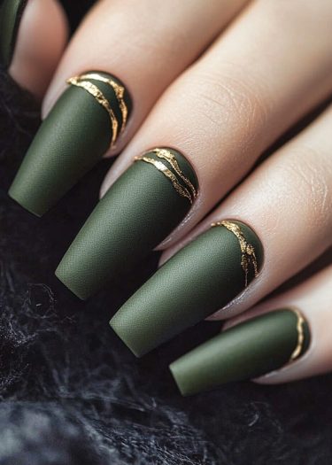 Stylish matte olive green nails with gold accents for an elegant manicure.