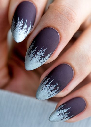 Elegant matte purple winter nail art with silver tips and detailed tree designs.