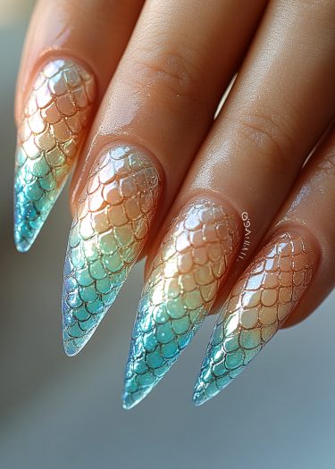 Stunning mermaid scale stiletto nails with iridescent colors and glossy finish.