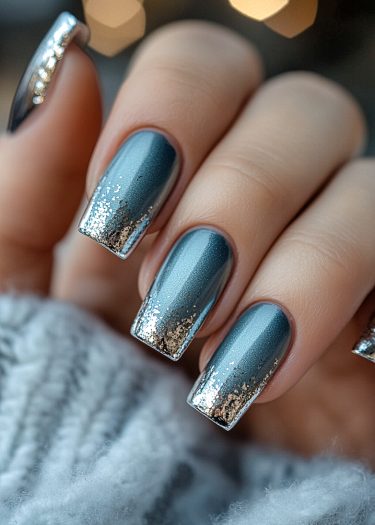 Elegant metallic bluish-grey nails with glitter gradient and textured background for a cozy ambiance.