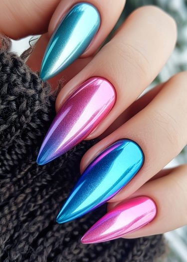 Vibrant stiletto nails with metallic gradient finish in blue, pink, and purple hues.