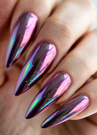 Stunning holographic stiletto nails in vivid magenta with a metallic iridescent finish.