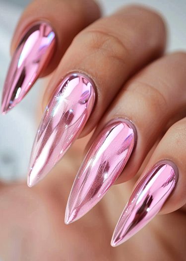 Glamorous metallic pink stiletto nails with a shiny chrome finish for a bold fashion statement.