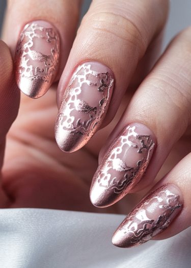 Elegant stiletto nails featuring metallic rose gold and blush pink designs for luxurious nail art.