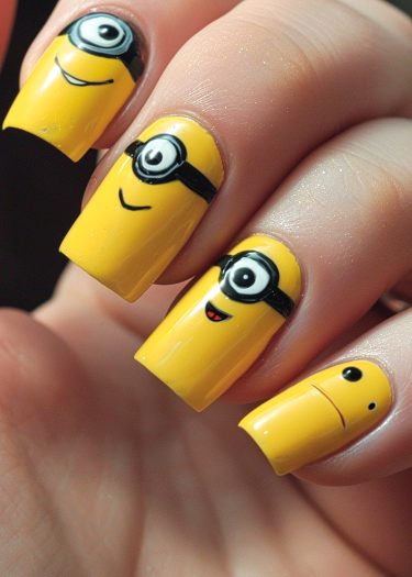 Bright yellow minion nail art featuring playful expressions and vibrant cartoon designs.