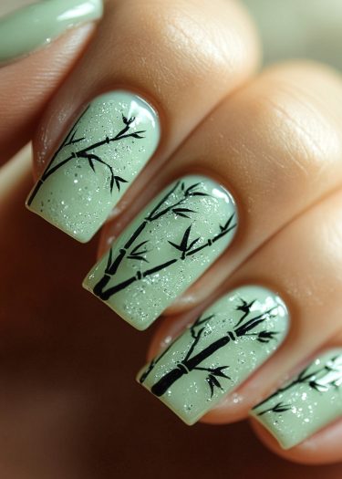 Elegant mint green bamboo nail art with sparkling details and intricate designs.