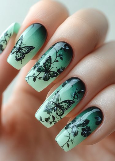 Elegant mint green butterfly nail art with intricate designs and a stunning ombre effect.