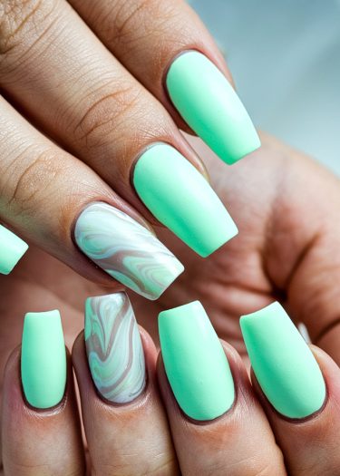 Elegant mint green square nails with marble accent design, showcasing modern nail art trends.