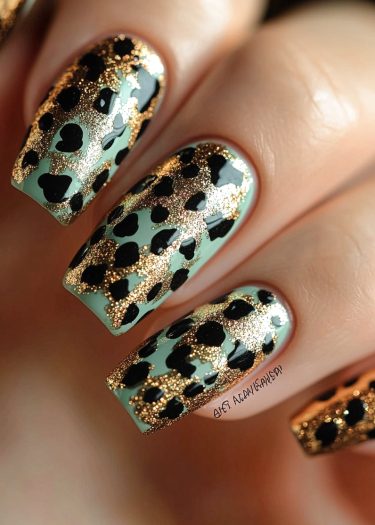 Elegant mint green leopard nail art with gold accents for a bold fashion statement.