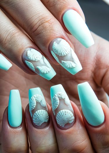 Elegant mint green coffin nails with 3D seashell designs for a beach-inspired look.