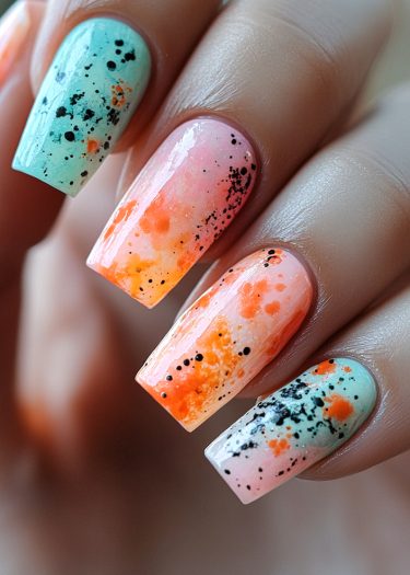 Vibrant mint, pink, and orange nail art with creative splatter design and glossy finish.