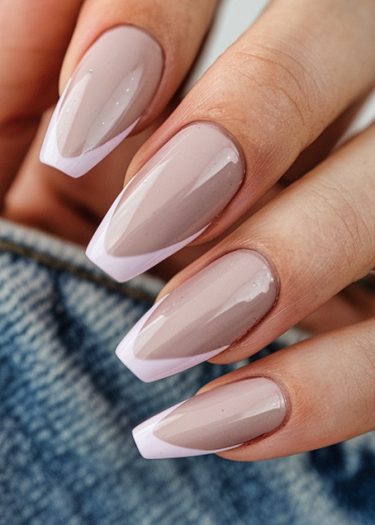 Elegant French manicure featuring nude tapered square nails with glossy finish.