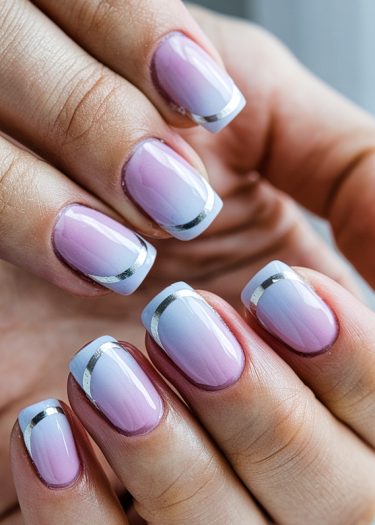 Sophisticated squoval nails with lavender-pink ombré and metallic French tips for elegant nail art.